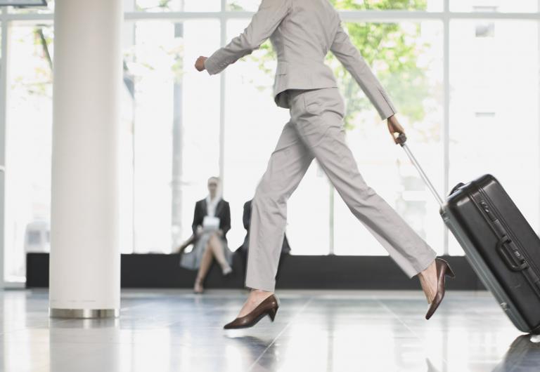 Woman dragging luggage at airport