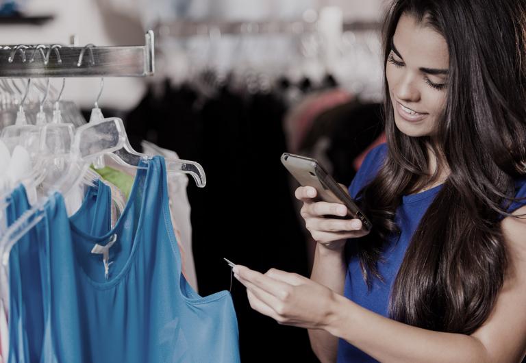 Woman shopping and looking at a blouse